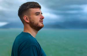 man standing by ocean looking out