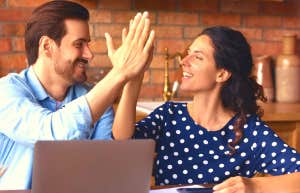couple high fiving after scheduling sex