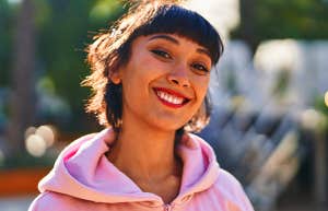 smiling girl in pink hoodie