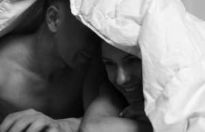 man and woman under covers