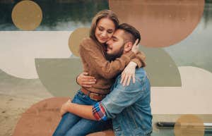 Couple hugging by the lake