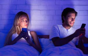 woman watching her man on his phone