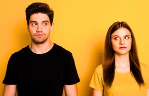 couple looking at each other suspicious of being set up