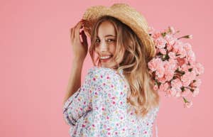happy woman smiling with flower bouquet