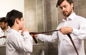 man and son getting dressed together