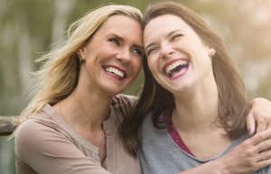 two sisters hugging and laughing