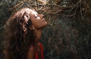 11 Traits Of A Strong But Sensitive Personality woman in the woods eyes closed
