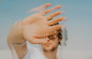 Man blurred with his hand up artistic 