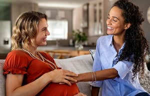 pregnant woman talking to friend