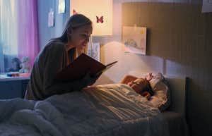mom reading bedtime story to daughter