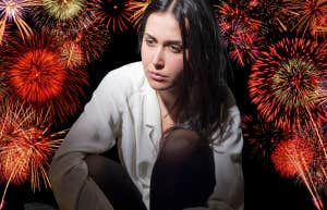 Woman feeling shame, surrounded by fireworks