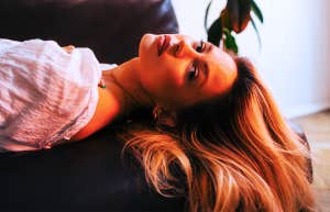 sad lonely woman laying on the couch