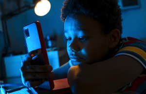 Why Refusing To Get Your Kid A Cell Phone Until 8th Grade Is A Huge Mistake young boy holding cellphone