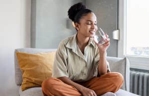 woman drinking water to calm anxiety