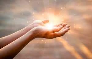 hands with light coming out of them spiritual
