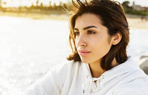 What to do before you look for a new job young woman sitting thoughtfully by a lake, thinking deeply