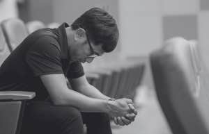 man crying in a chair