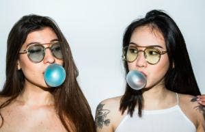 two women chewing bubblegum