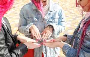 three woman showing off their nails