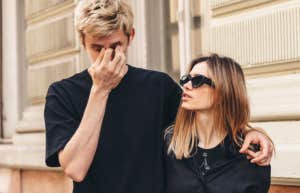 Couple walking down the road, man looking very upset