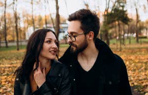 The Unusual Relationship The Happiest Couples Have, According To Research man and woman walking together in park