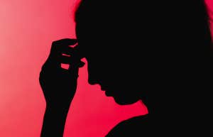 stressed woman against red background