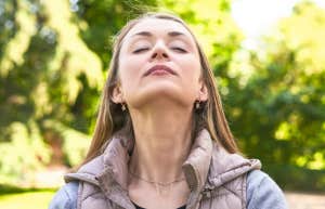 Why Some People Age Faster Than Others, According To Research mature woman looking toward the sky