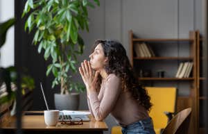 annoyed woman sitting at a desk