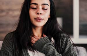 devastated woman holding hand over her heart