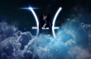 man sitting on pisces symbol in the sky
