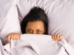 woman hiding under the covers after sex feel shame