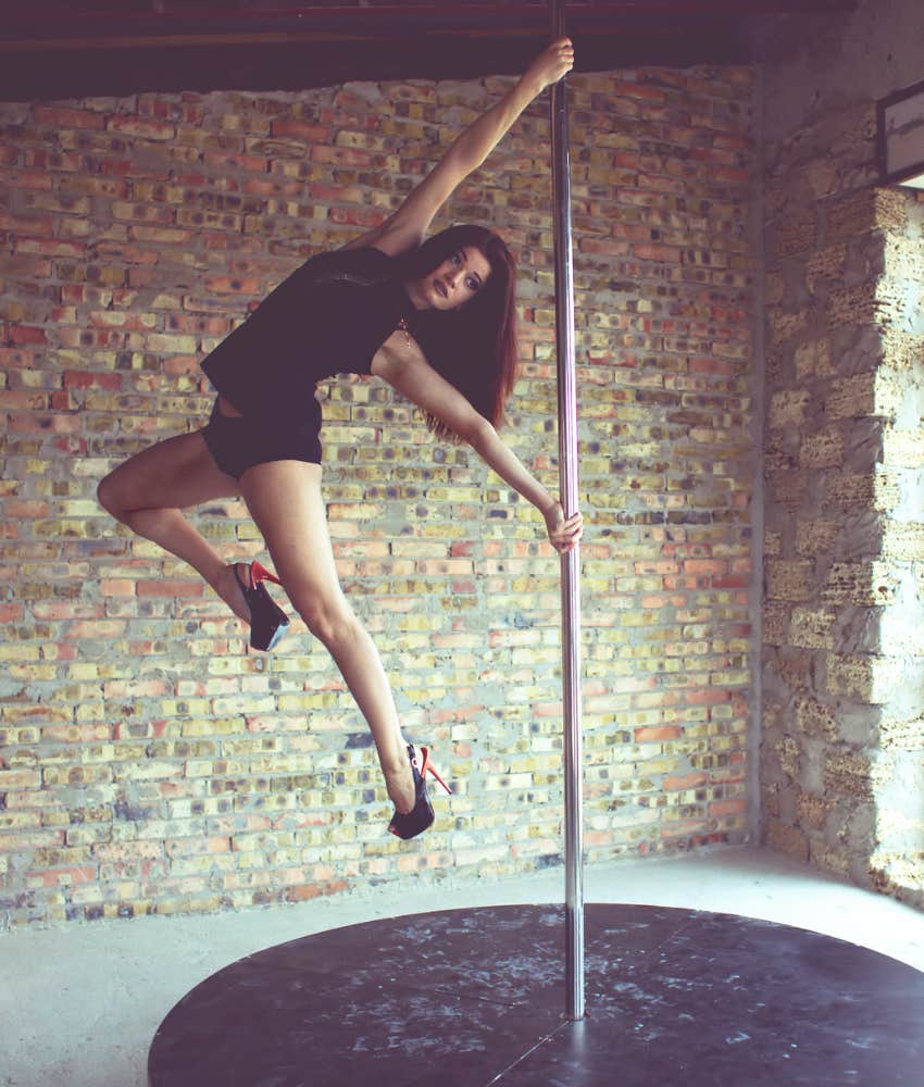 woman doing acrobatics on a pole