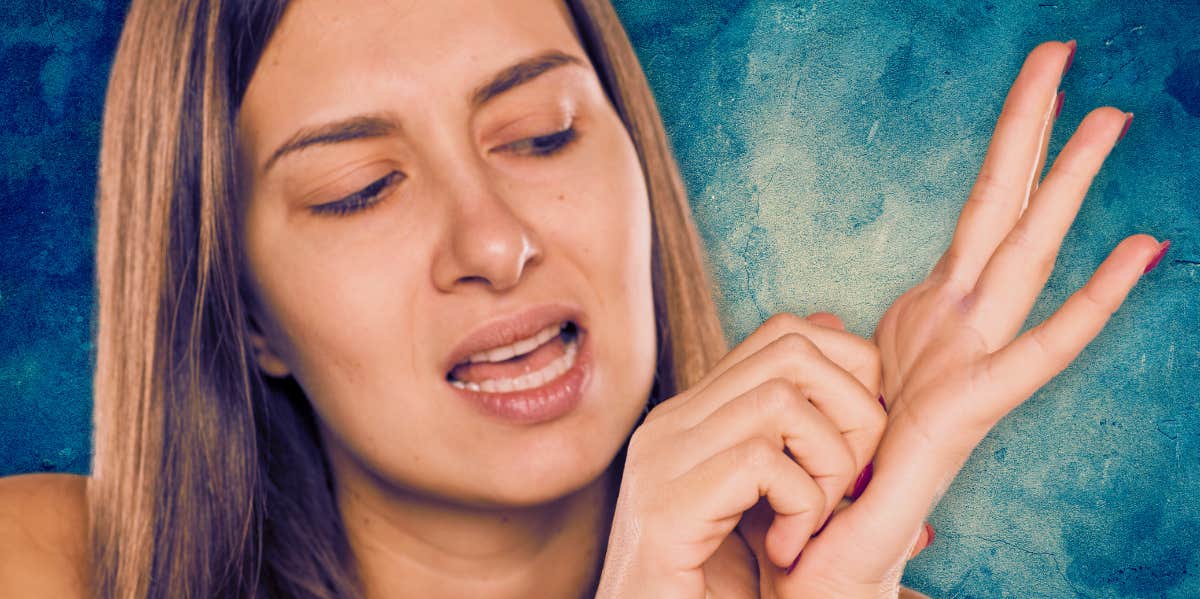 woman itching her left palm